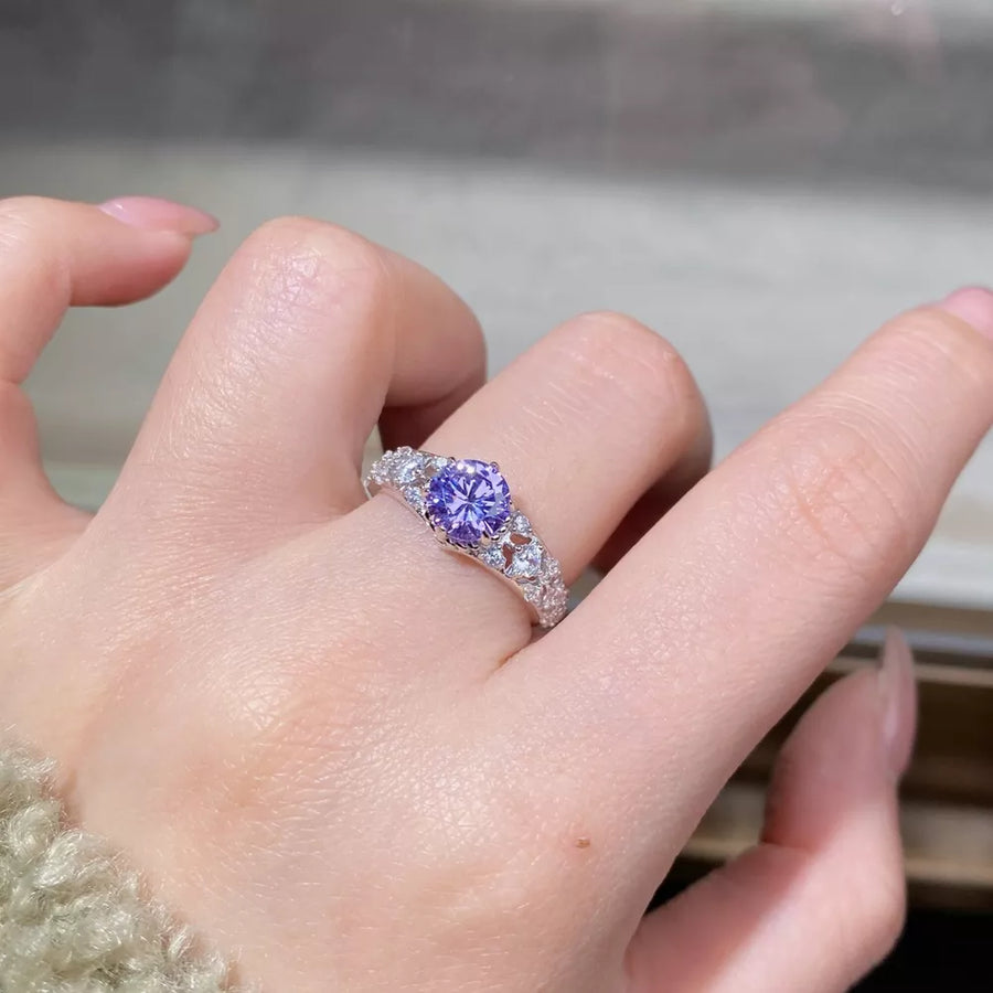 silver ring featuring faceted stones and ornate