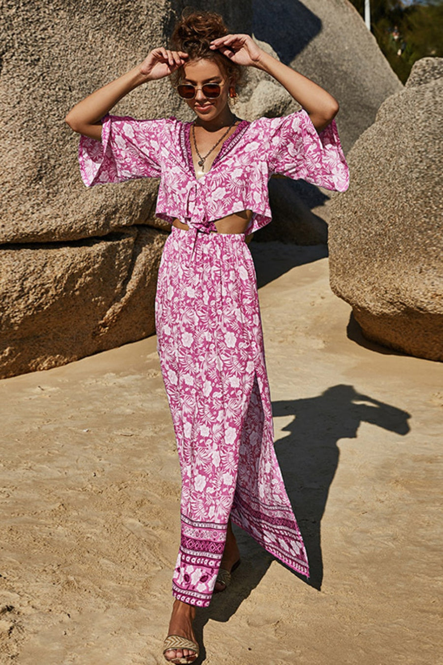 Pink floral crop top with tie front and wide sleeves, paired with a high-waisted maxi skirt with side slit.
