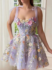 Floral embellished mini dress in lavender with tie straps and a full skirt.
