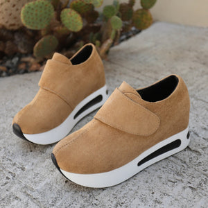 Brown chunky platform sneakers with air cushion and hook-and-loop closure.