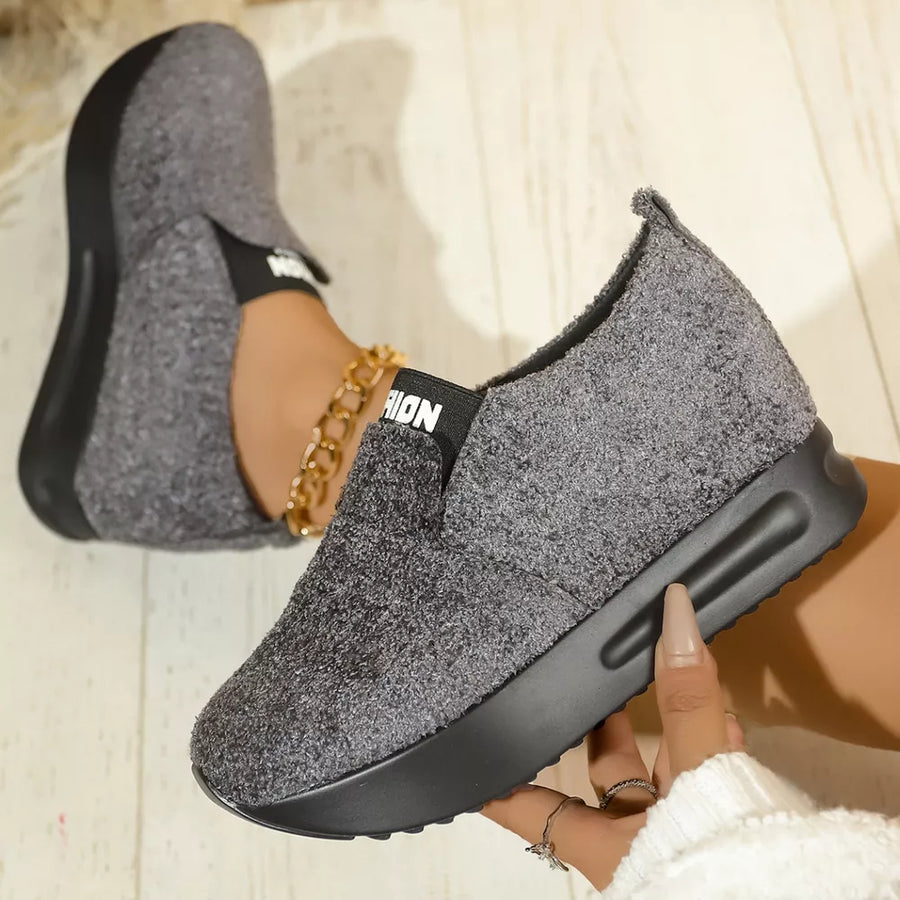 Textured gray round toe platform sneakers with black sole and elastic band detail.