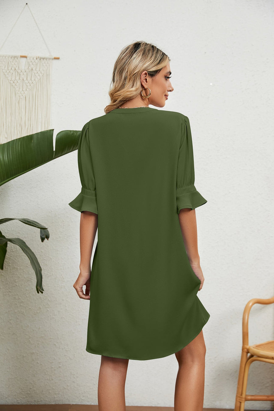 Green V-neck shift dress with flutter sleeves and a relaxed fit.