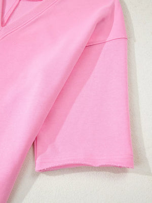 Pink cotton romper with half sleeves and raw hem detail