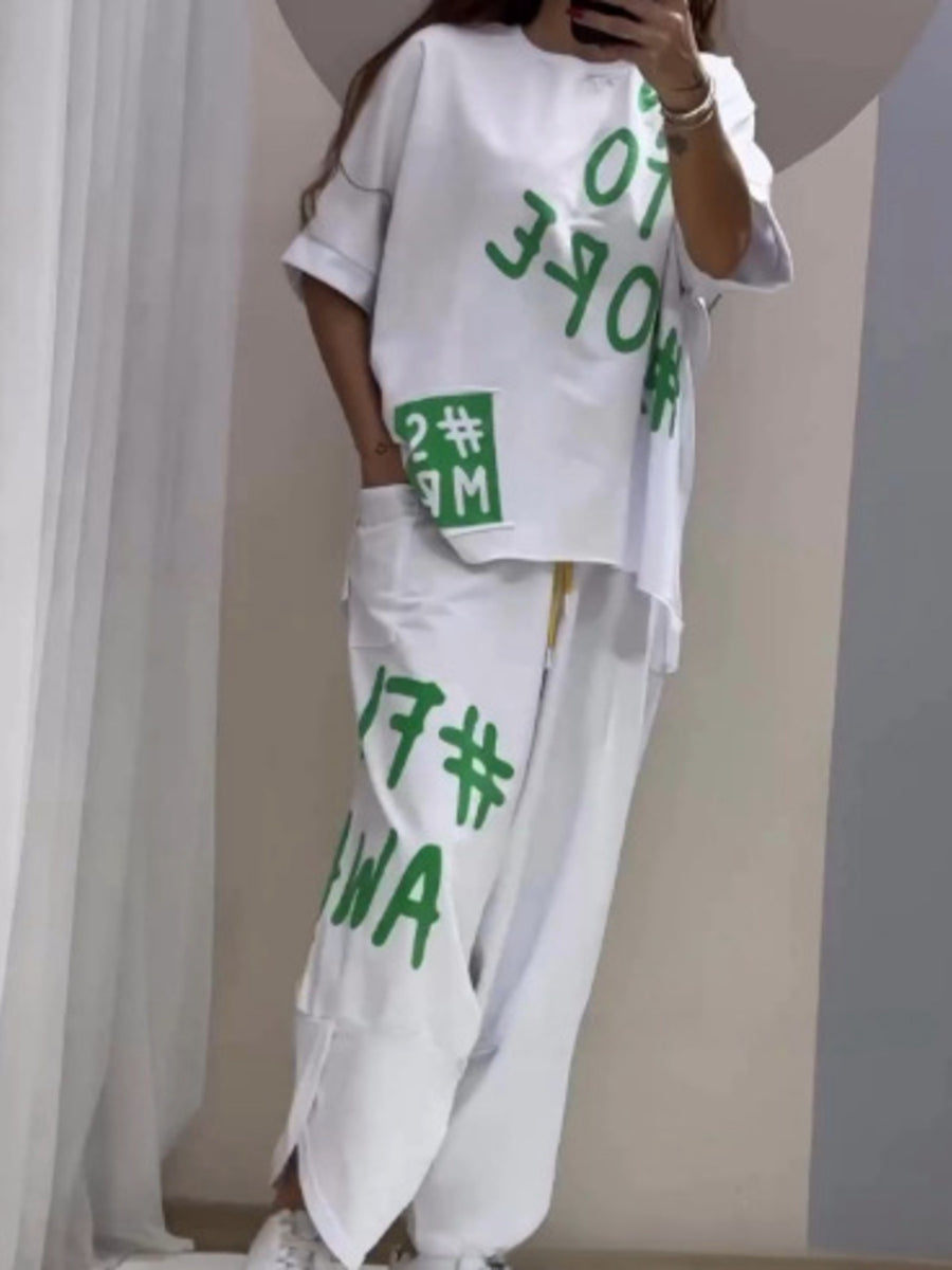 White graphic tee and drawstring pants set with bold green lettering and numbers.