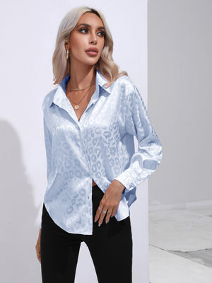 Light blue satin leopard print blouse with button front and long sleeves