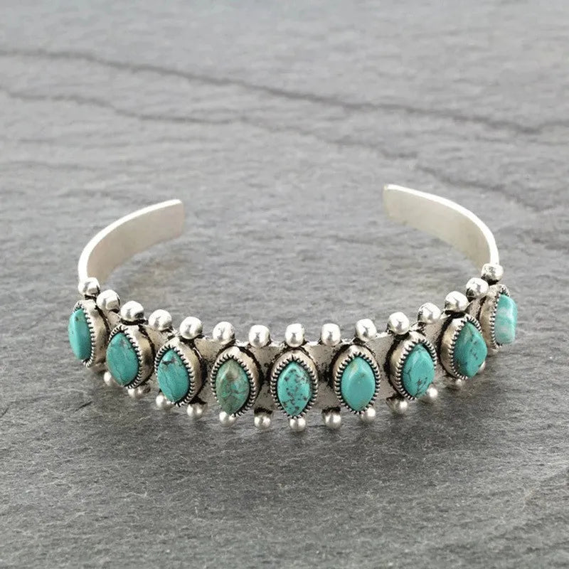 Turquoise cabochon open bangle bracelet with silver beaded accents