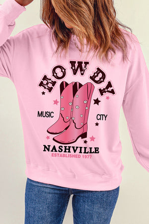Blush pink graphic crewneck sweatshirt with cowboy boots and Nashville text.