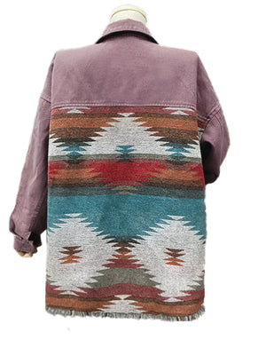 Aztec print oversized trucker jacket in mauve with fringe hem and colorful geometric pattern on back.