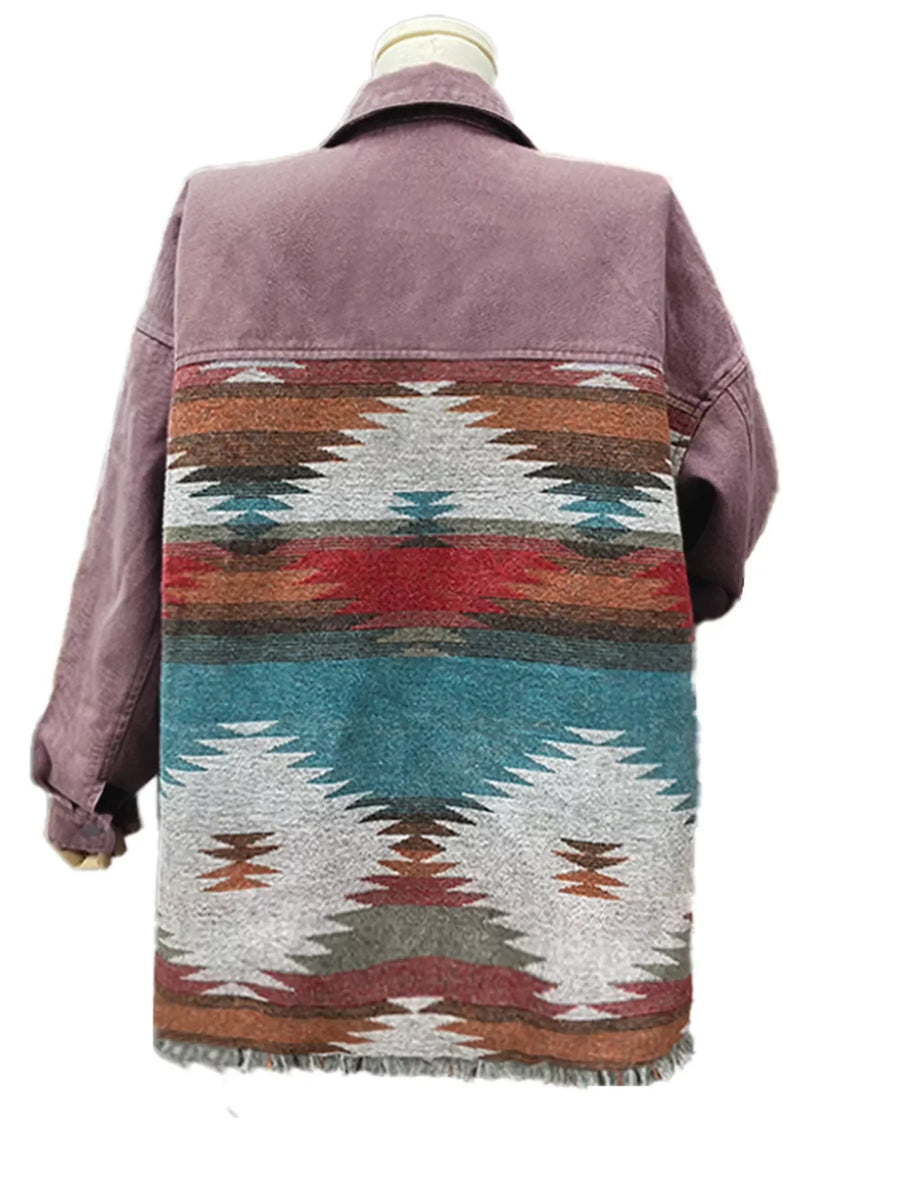 Aztec print oversized trucker jacket in mauve with fringe hem and colorful geometric pattern on back.