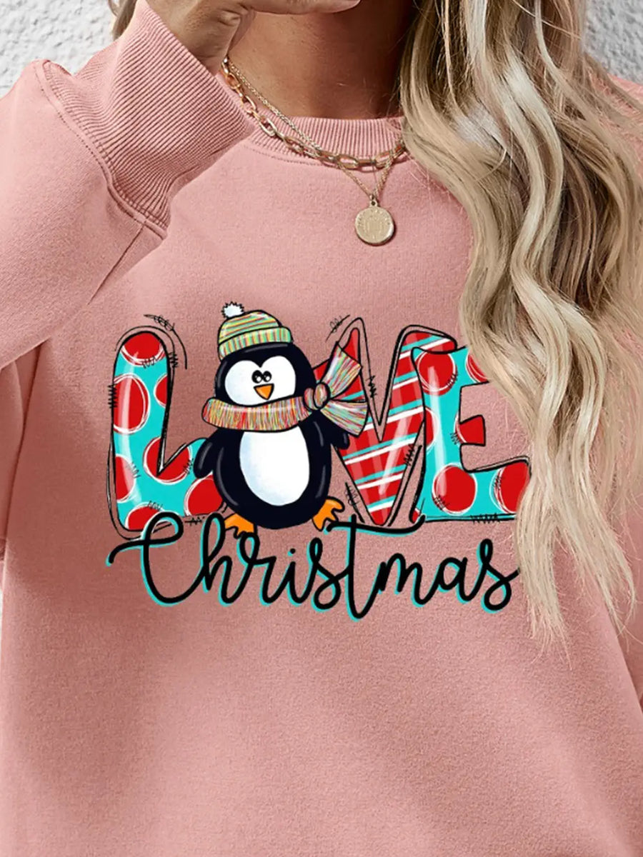 Blush pink sweatshirt with festive penguin graphic and "Christmas" text.