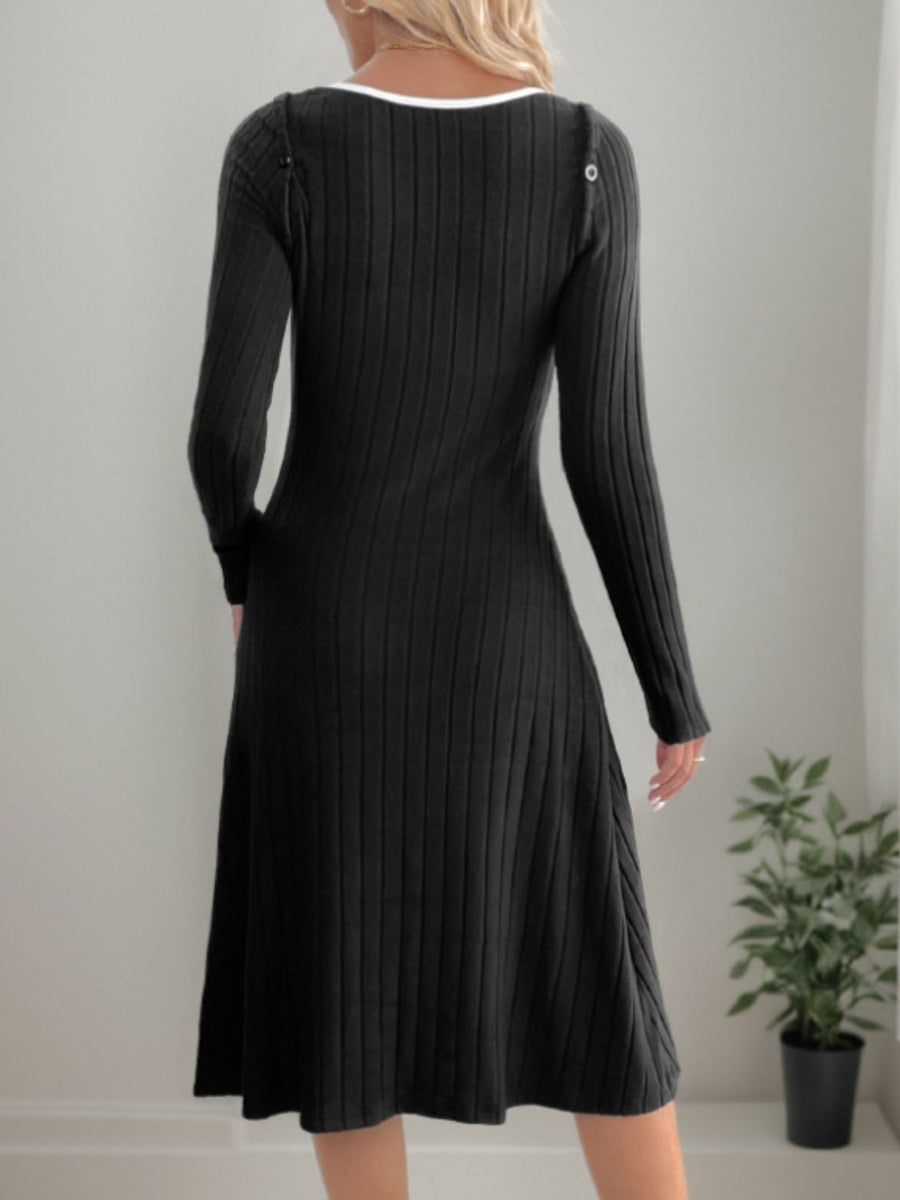 Black ribbed knit dress with long sleeves and a white neckline detail.