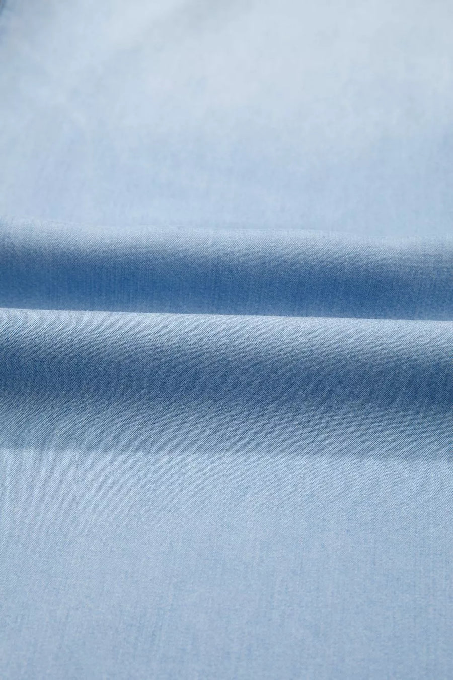 Light blue denim fabric with soft folds