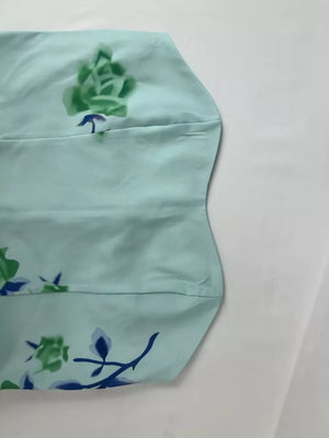 Mint blue floral print tube maxi dress with green and blue floral details.
