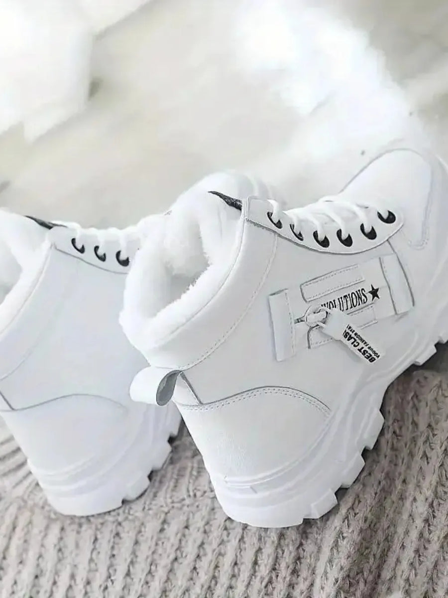 White faux shearling lined platform boots with zip detail and lug sole.