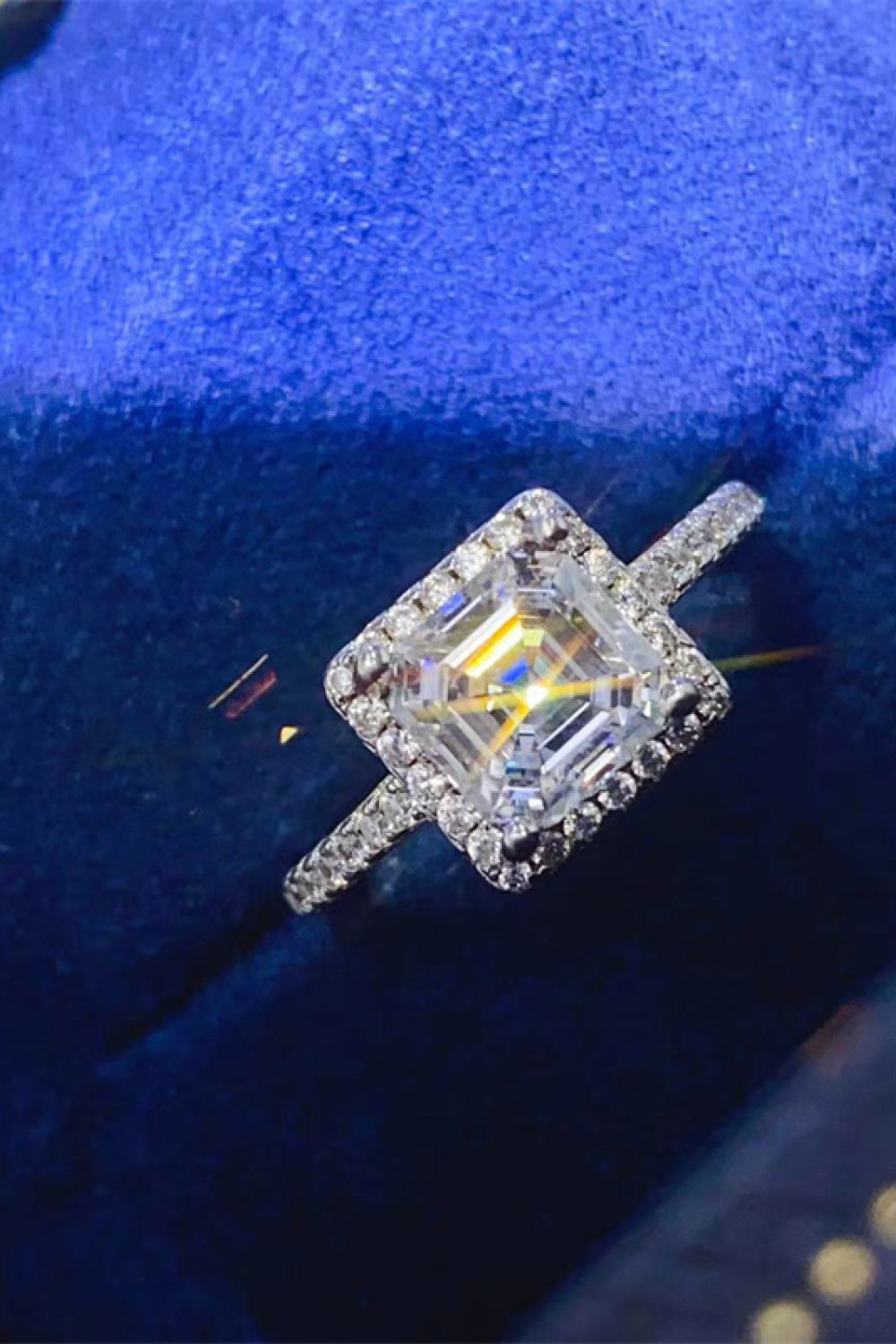 Silver Asscher cut moissanite halo ring with a diamond band.