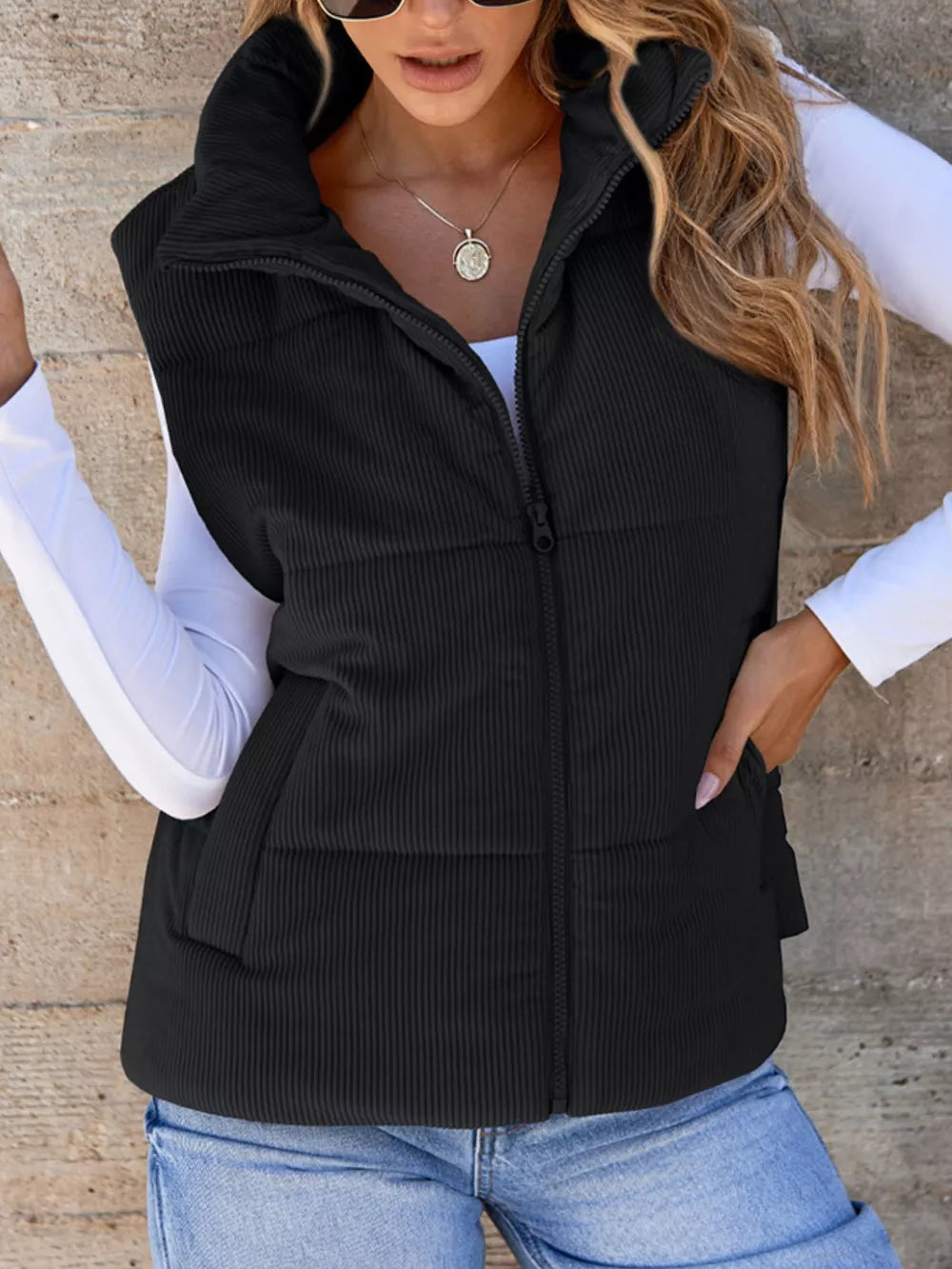 Black corduroy zip-up vest with pockets and a stand-up collar.
