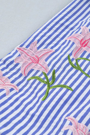 Blue and white striped button-down shirt with pink floral embroidery and green stems.