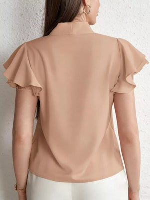 Beige tie-neck blouse with ruffle sleeves and lace trim detail.