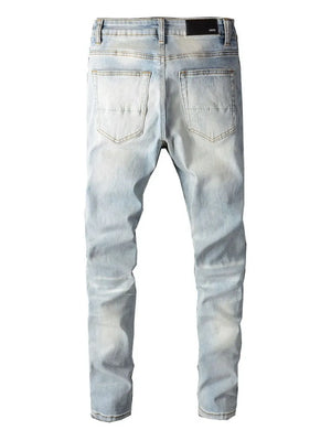 Light wash distressed slim-fit jeans with a five-pocket design and a black brand patch.