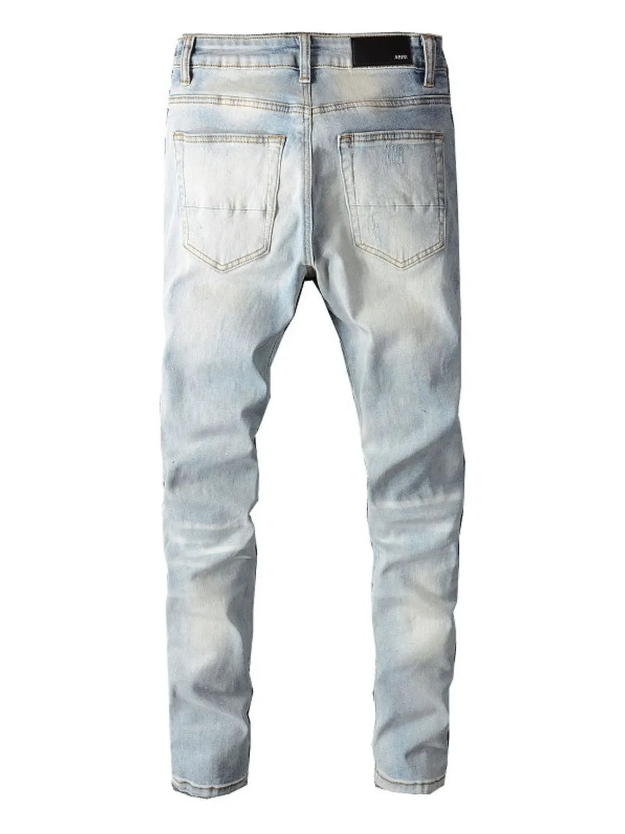 Light wash distressed slim-fit jeans with a five-pocket design and a black brand patch.