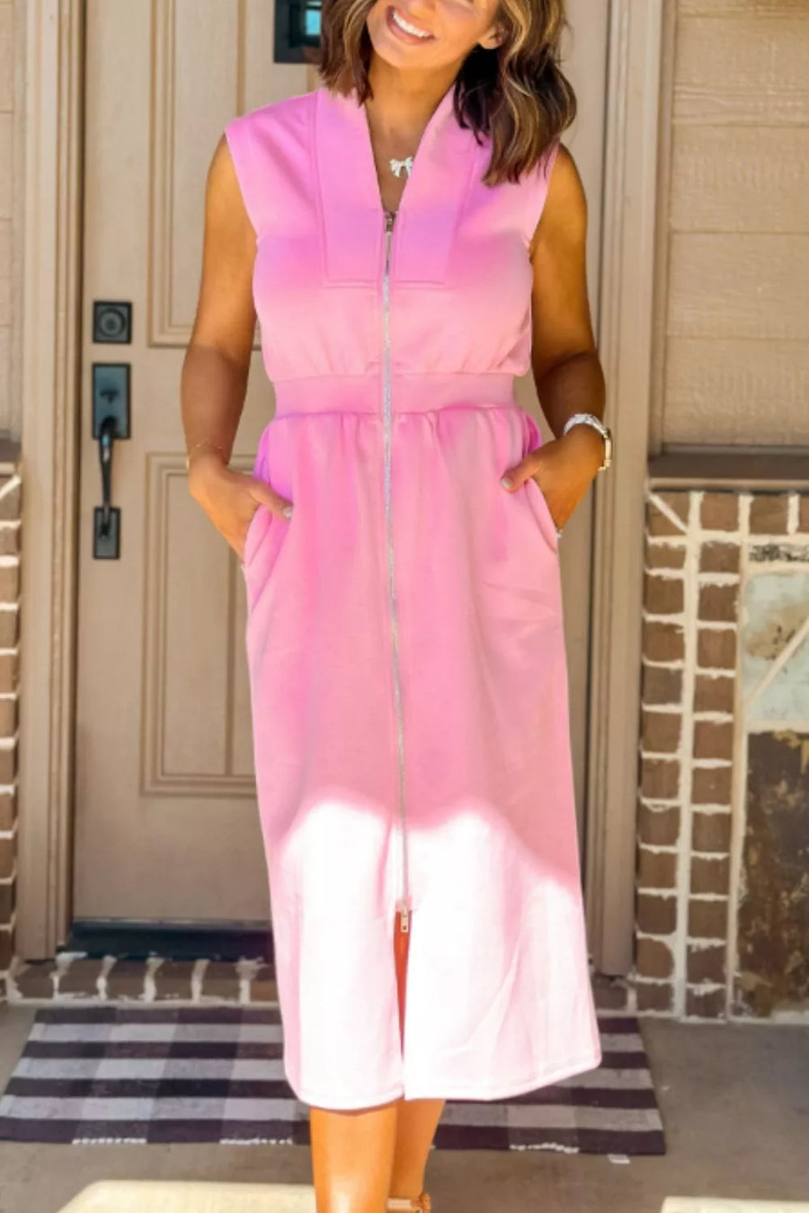 Pink sleeveless midi dress with zipper detail and pockets