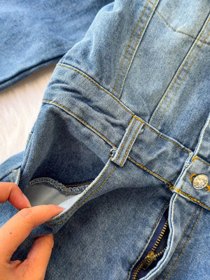 Chic buttoned denim jumpsuit with pockets and zipper detail
