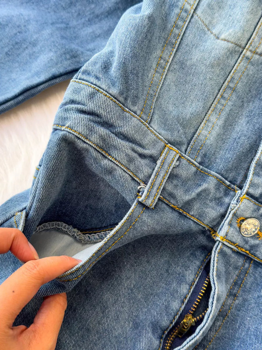 Chic buttoned denim jumpsuit with pockets and zipper detail