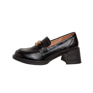 Black patent leather loafers with chunky block heel and gold buckle detail.