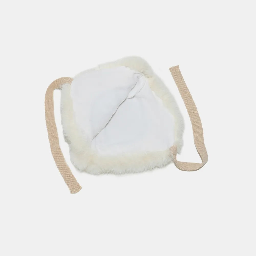 Faux fur trim trapper hat in ivory with tan straps and white lining.