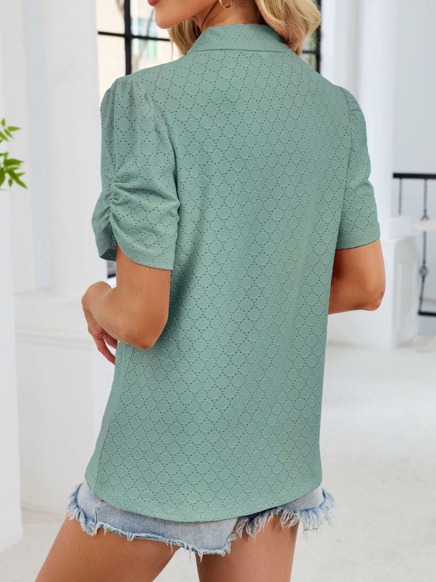 Sage eyelet ruched short sleeve blouse with a collared neckline.