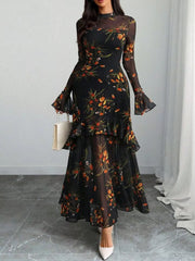 Black floral mermaid maxi dress with sheer flounce sleeves and tiered ruffles.