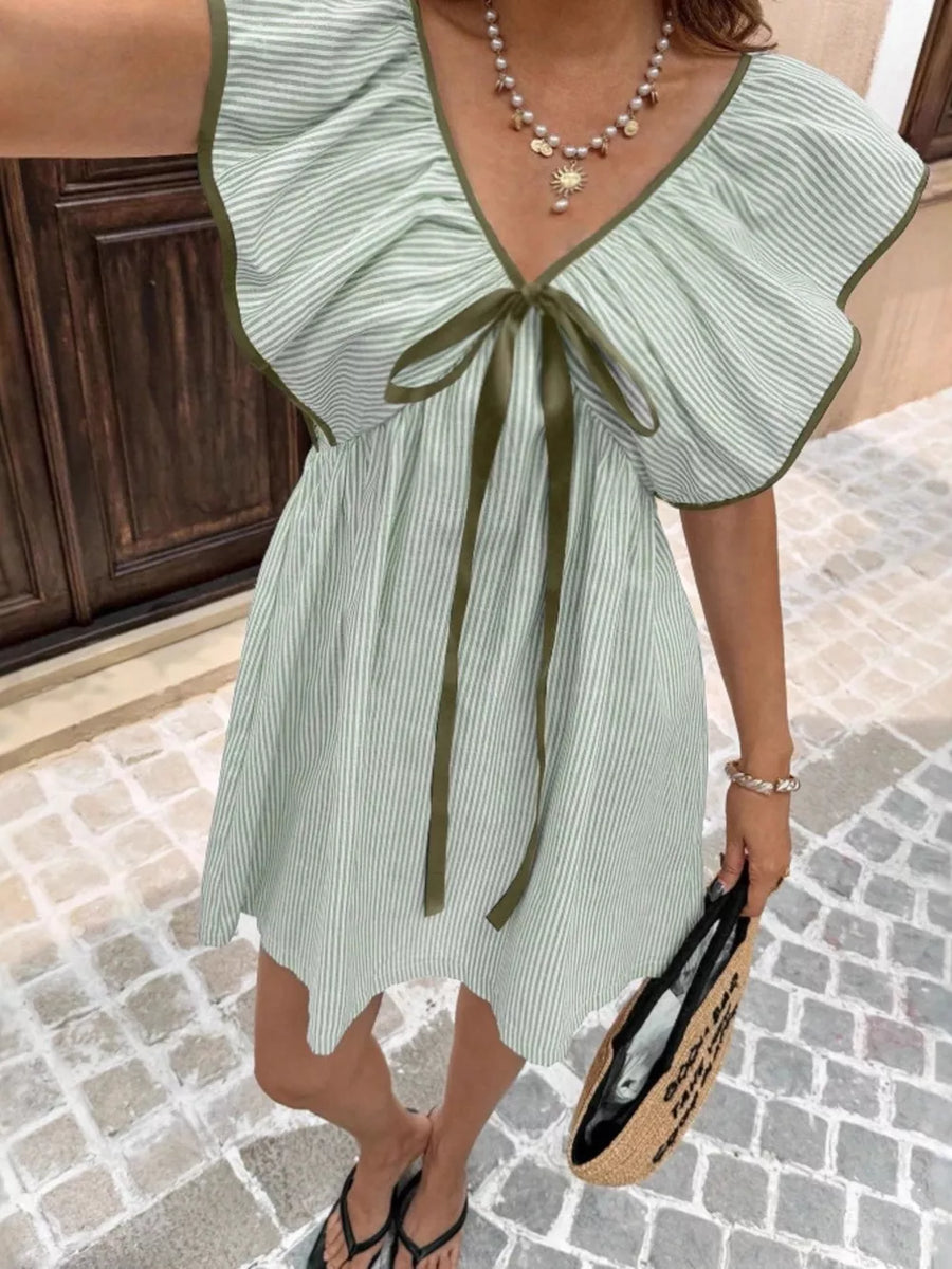 Green striped mini dress with ruffled sleeves, V-neck, and bow detail.