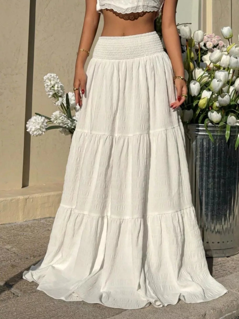 White tiered maxi skirt with smocked waist and crinkled texture