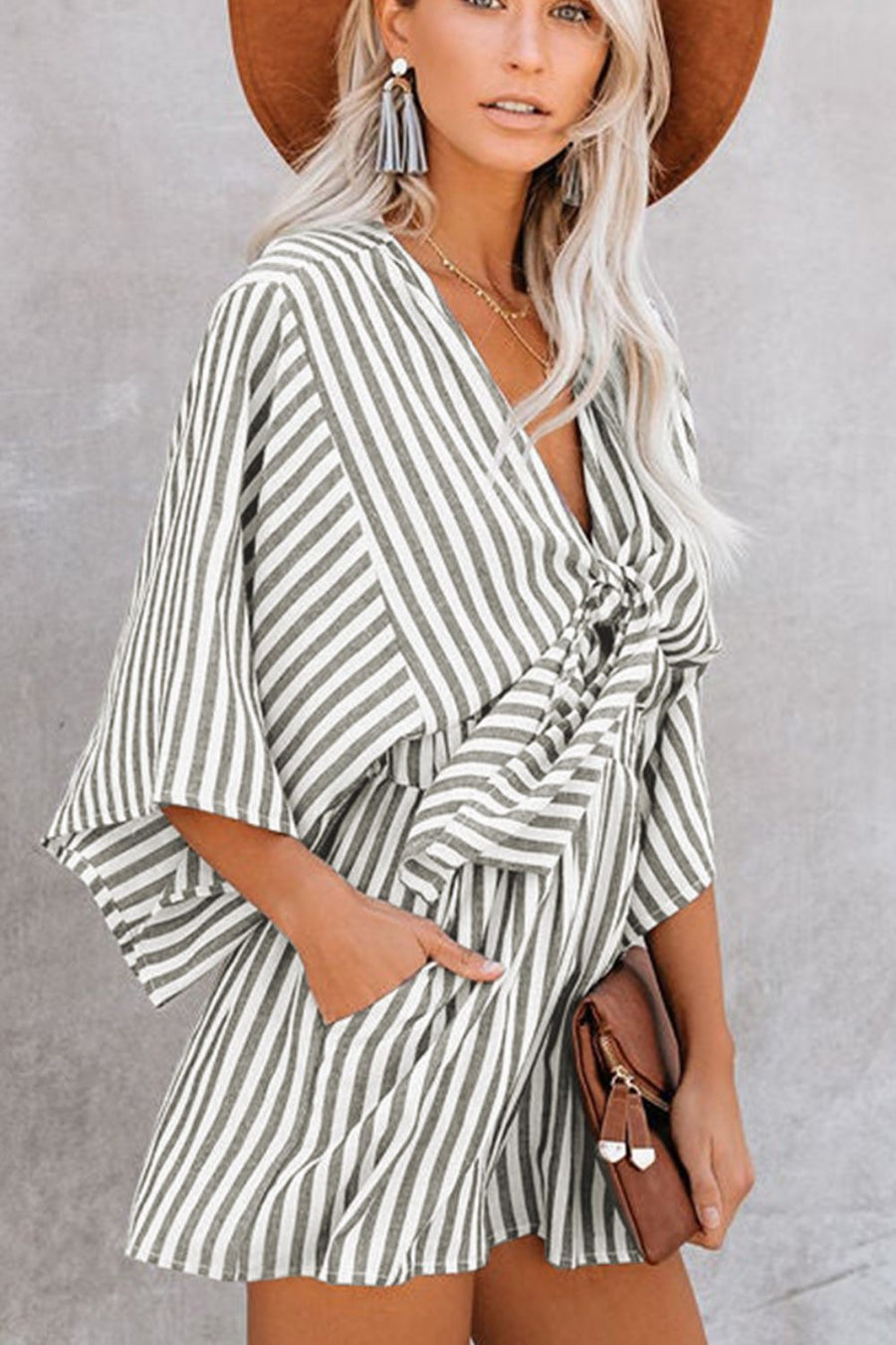 Striped tie-front kimono jumpsuit in dark gray with wide sleeves and pockets.