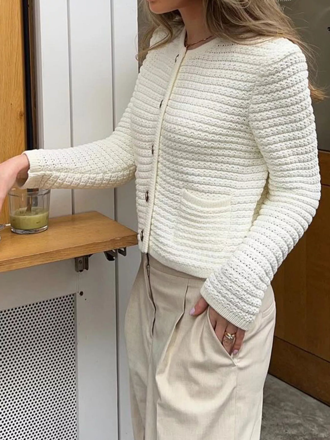 Textured button-down cardigan in gray/white with two front pockets and acrylic knit.