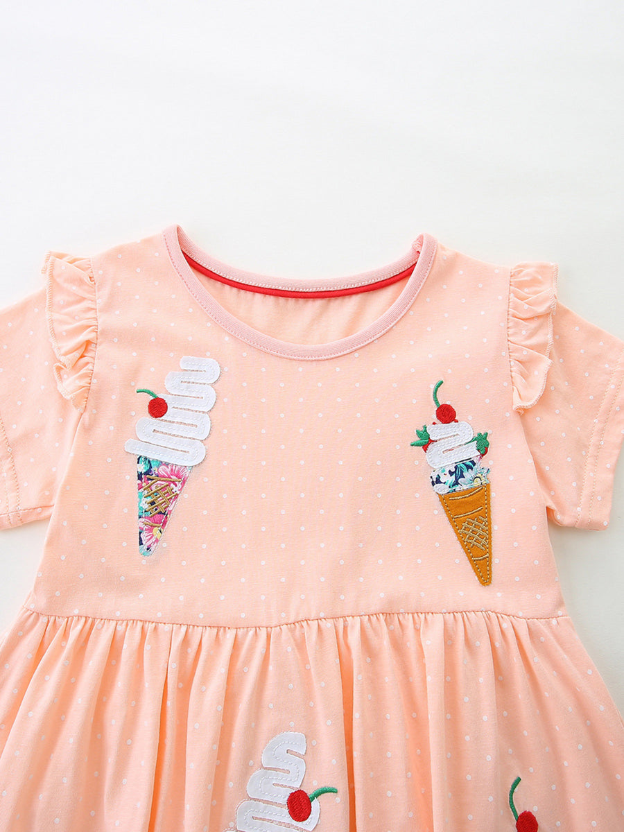 Peach polka dot cotton dress with ice cream applique and ruffled sleeves.