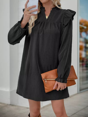 Black ruffled notched sleeve dress with gathered neckline and cuffs.