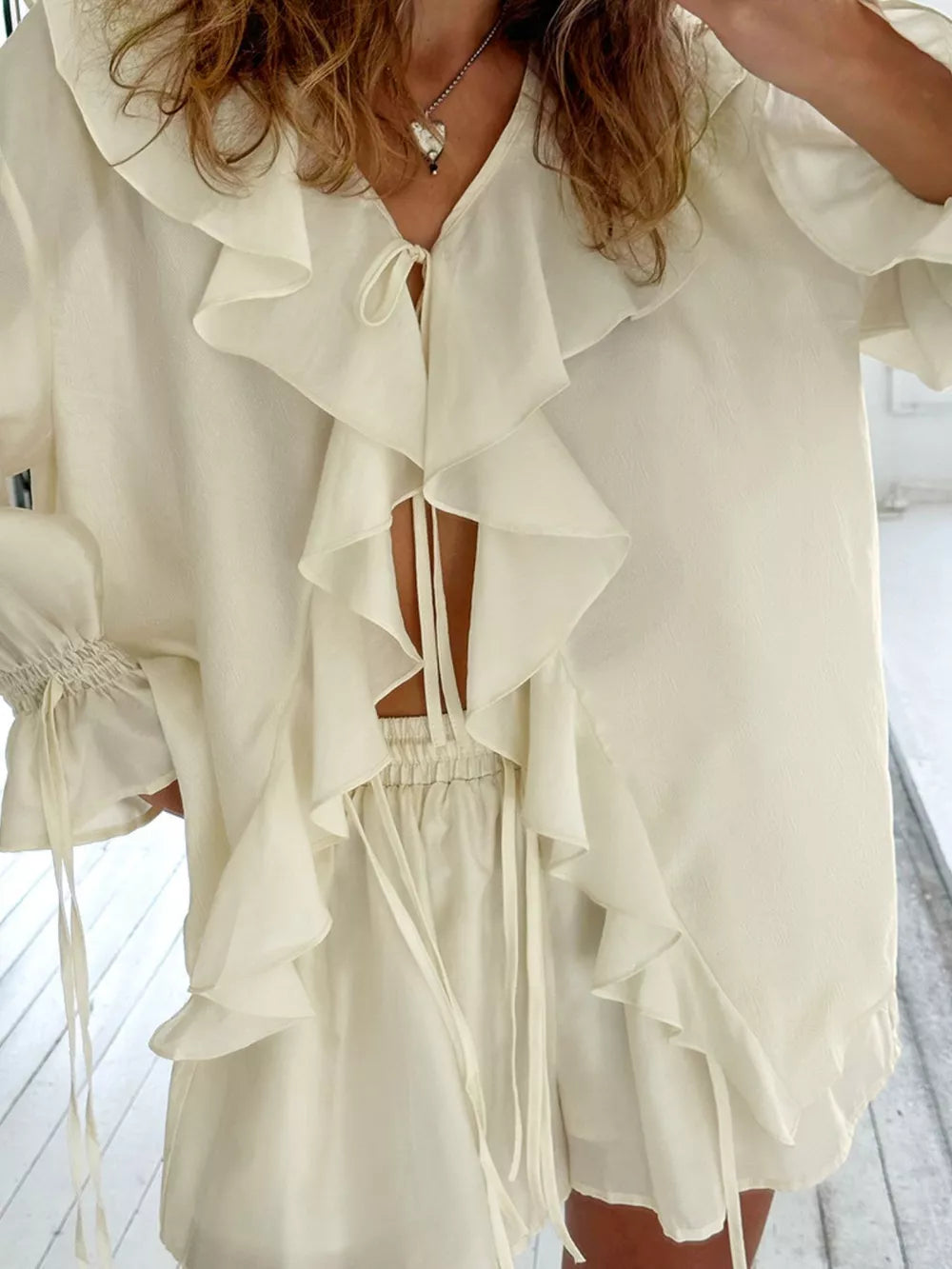 ivory blouse with hip-length and tie
