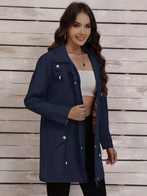 Navy blue drawstring trench coat with snap-down details and plaid lining.