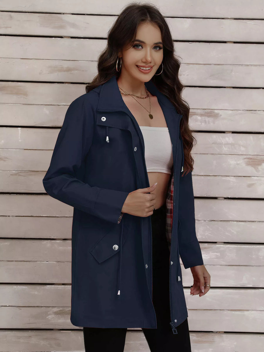 Navy blue drawstring trench coat with snap-down details and plaid lining.