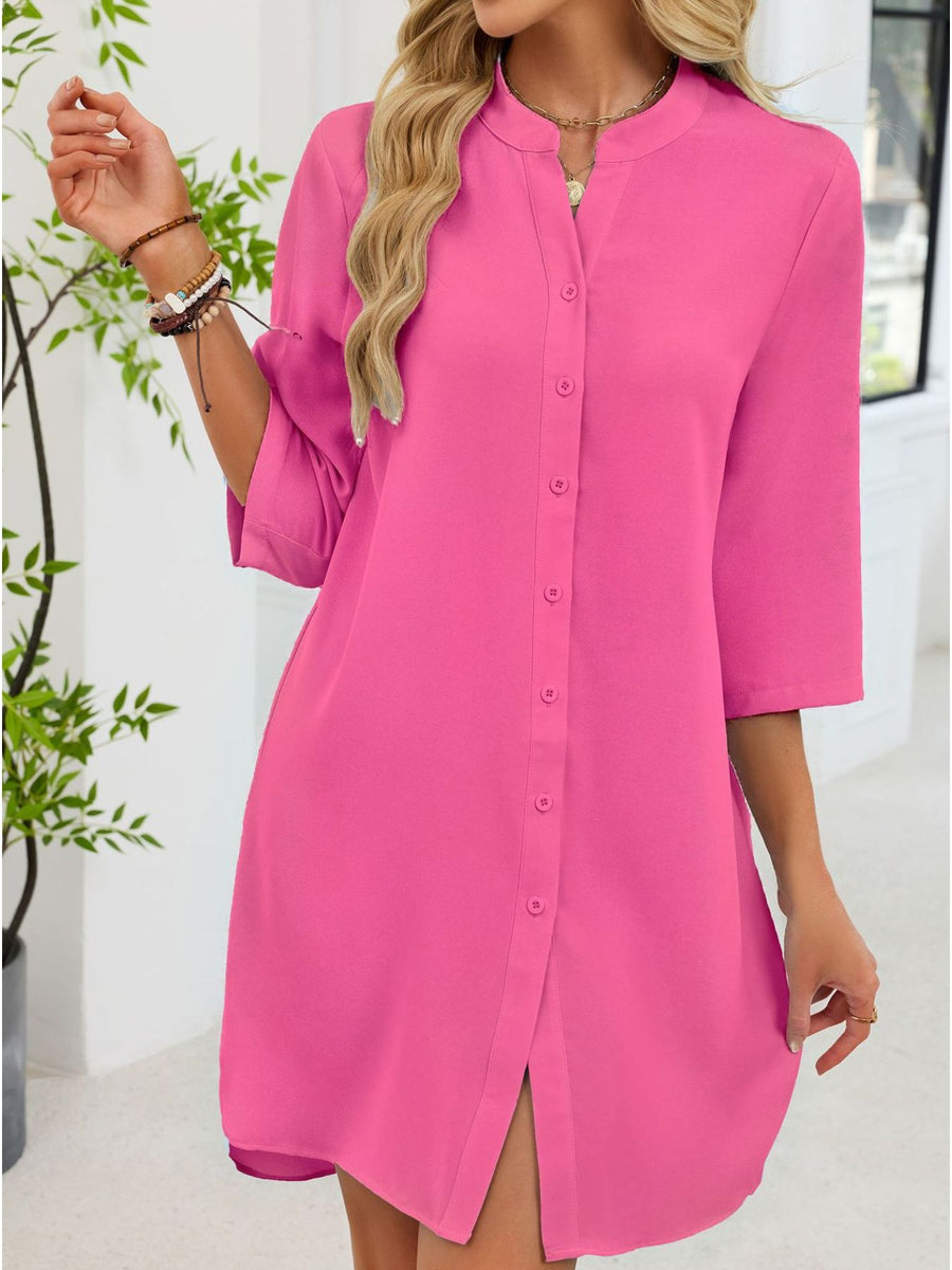Fuchsia pink button-down shirt dress with band collar and 3/4 sleeves.