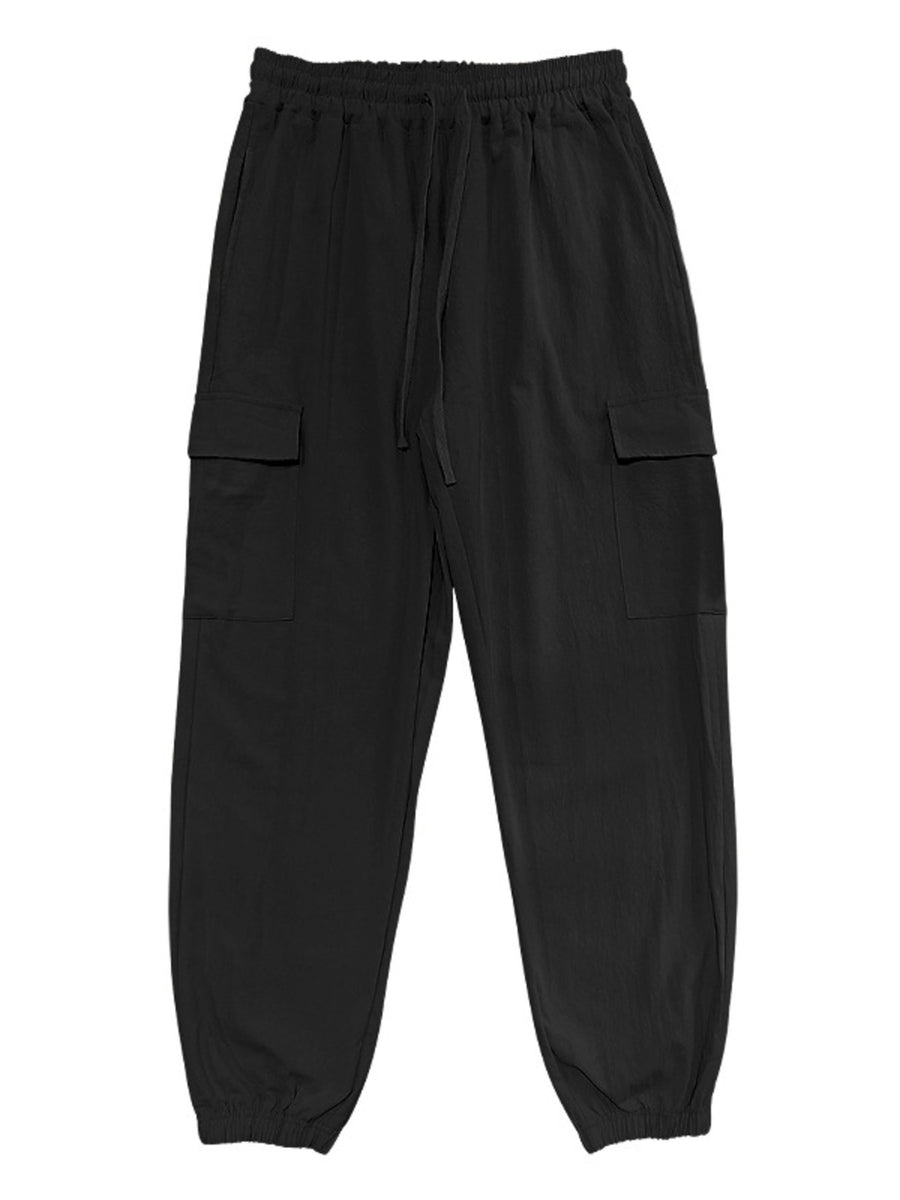 Black cargo pants with drawstring waist and elastic cuffs.