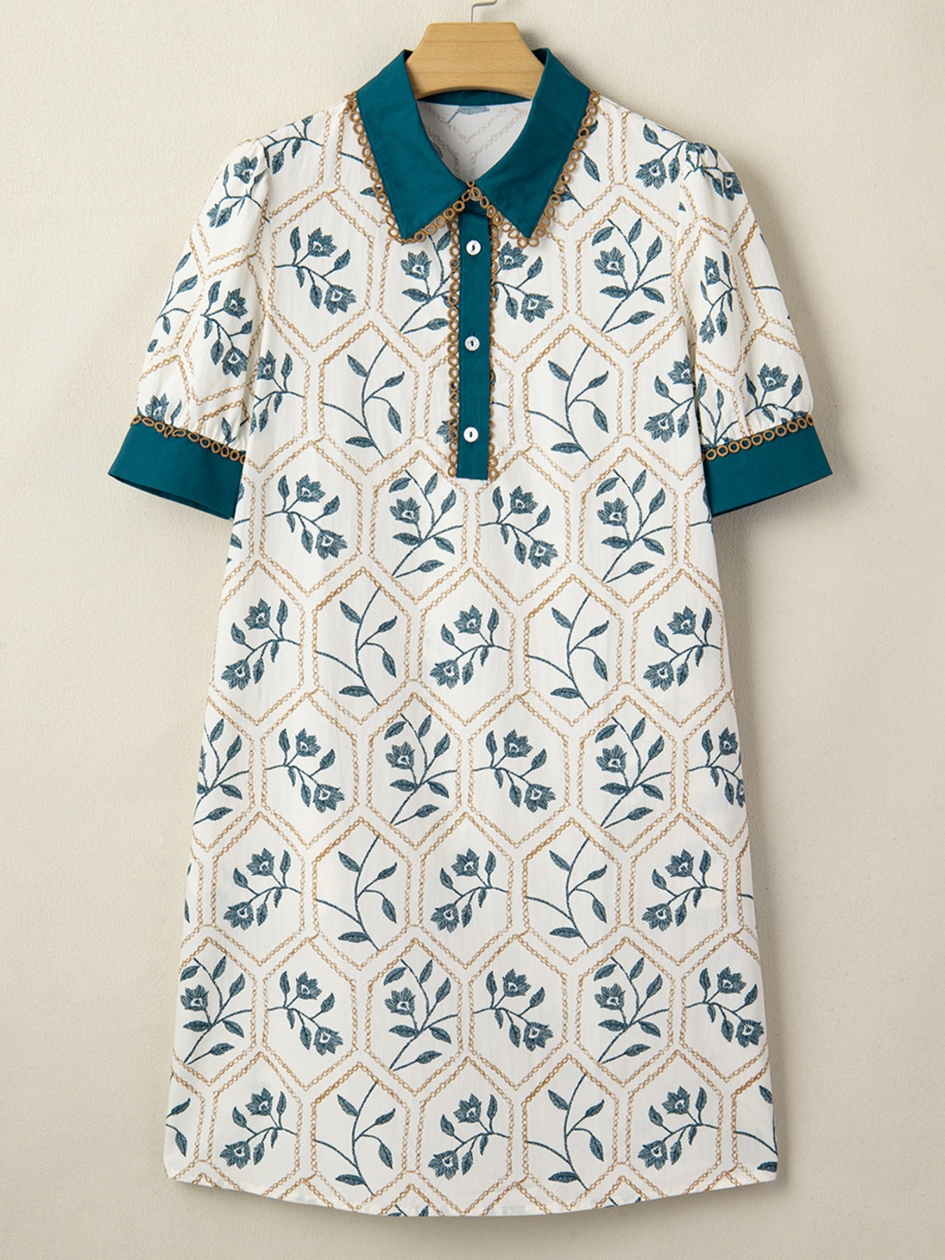 Floral print polo collar mini dress with button detail and contrast trim.