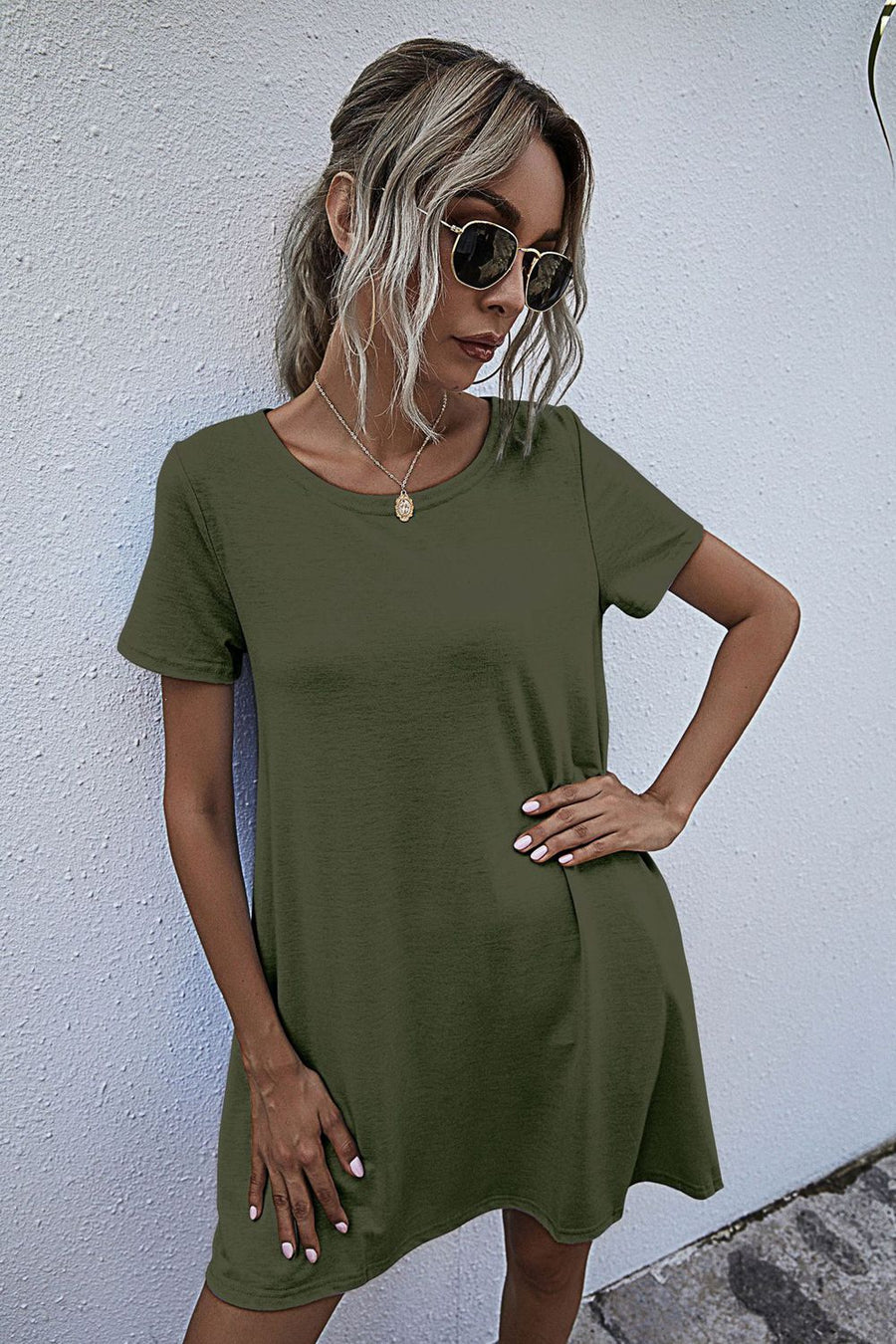 Army green relaxed tee dress with short sleeves and pockets, styled casually.
