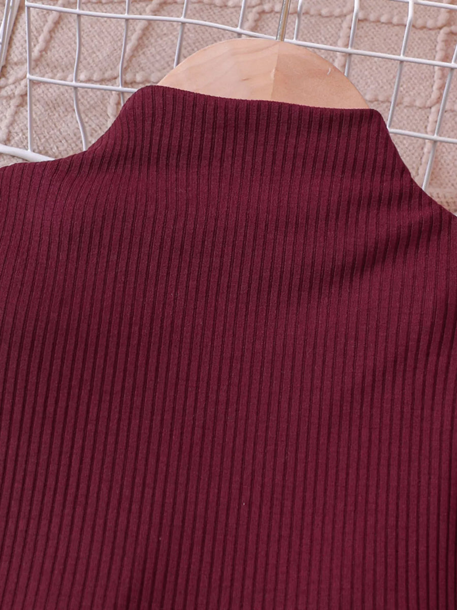 Wine red ribbed mock neck baby top with puff sleeves.