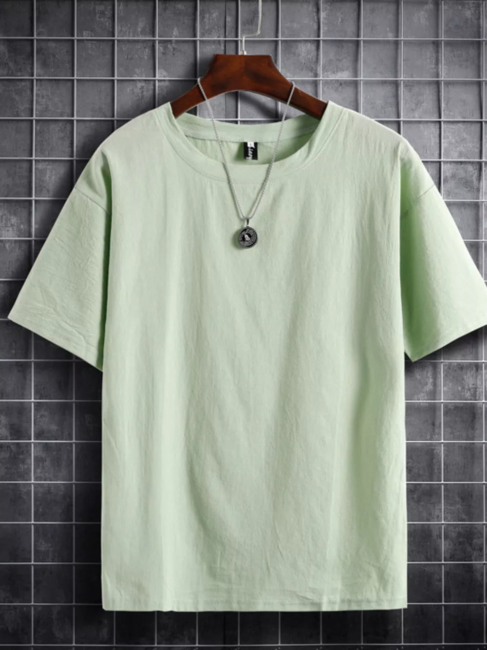 Light green cotton crew neck t-shirt with short sleeves and a relaxed fit.