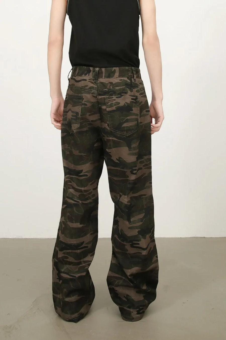 Camo wide-leg utility trousers in green camouflage with cargo pockets.