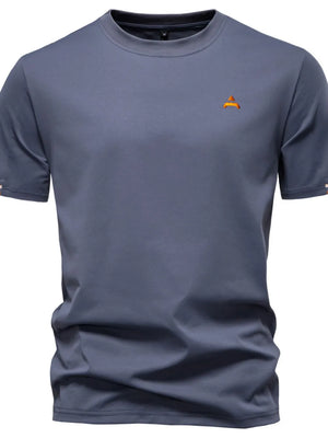 Dusty blue crewneck t-shirt with embroidered orange crest detail on chest
