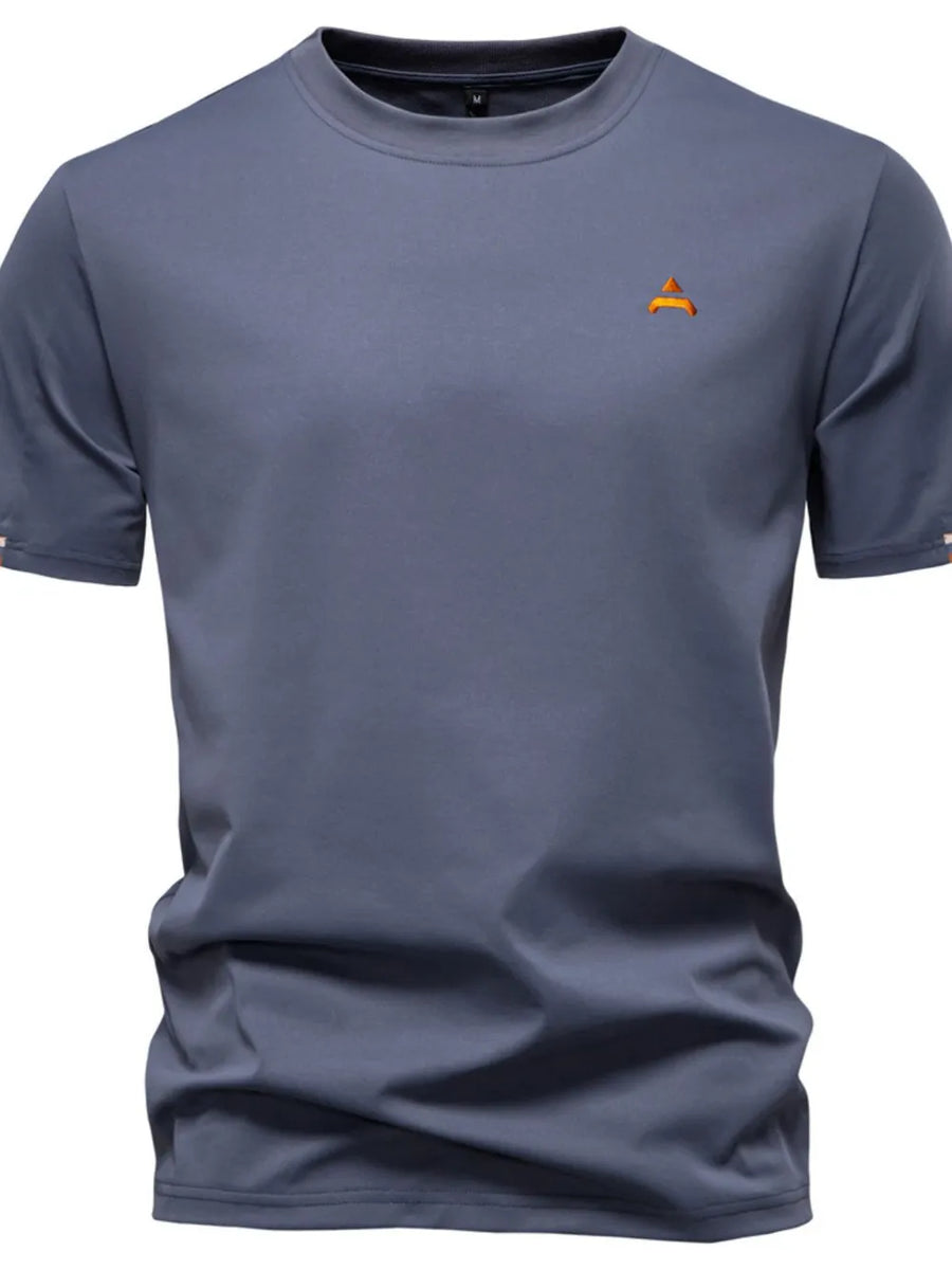 Dusty blue crewneck t-shirt with embroidered orange crest detail on chest