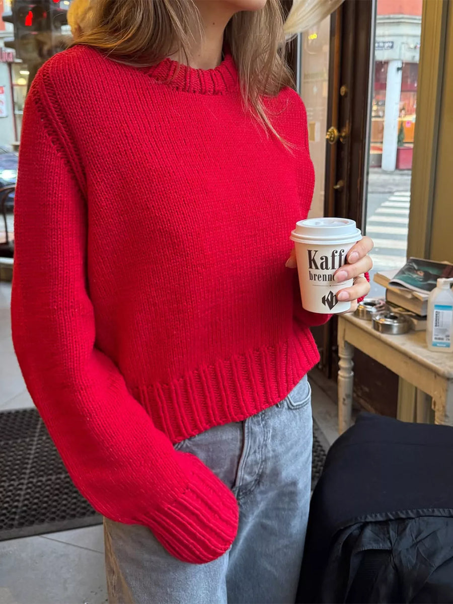 Red ribbed round-neck knit sweater with textured neckline and cuffs.